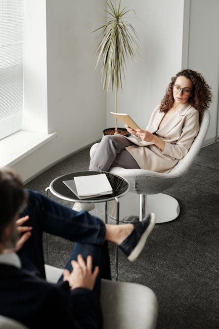A professional woman conducting a business meeting in a modern office.